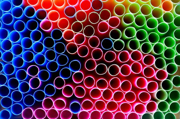 A close up pic of the tops of an array of different coloured plastic straws